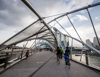 Bridge against cloudy sky