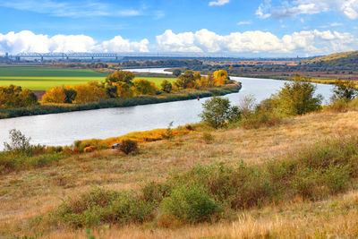 A beautiful autumn landscape with a smooth bend of the river among the plain.