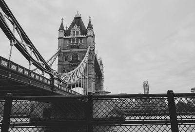 Low angle view of bridge and buildings against sky