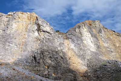 Low angle view of rock formation against sky