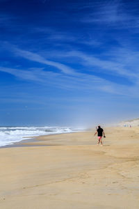 Man on beach against sky