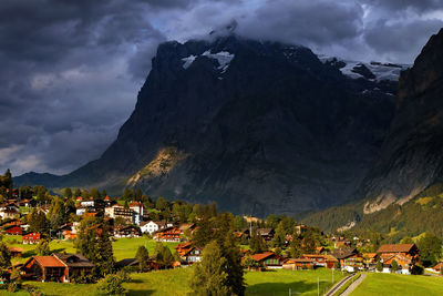 Town by mountains against sky