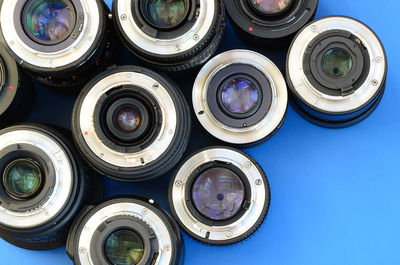 Directly above shot of various lenses on blue background