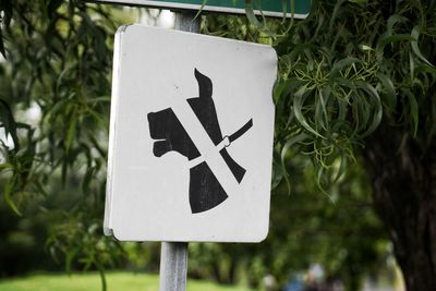 Close-up of arrow sign on road