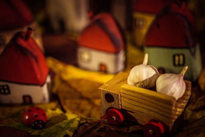 Close-up of wooden houses and artificial lady bug decorated on table