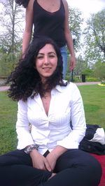 Portrait of smiling young woman sitting outdoors