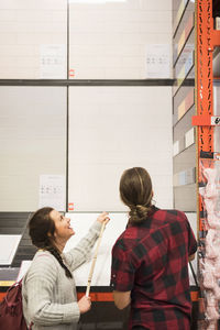 Couple examining tiles at hardware store