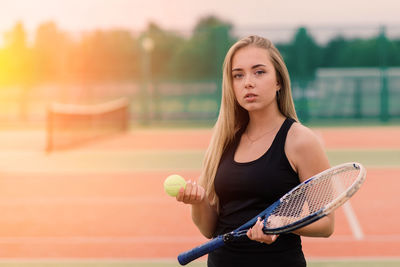 Portrait of young woman playing tennis
