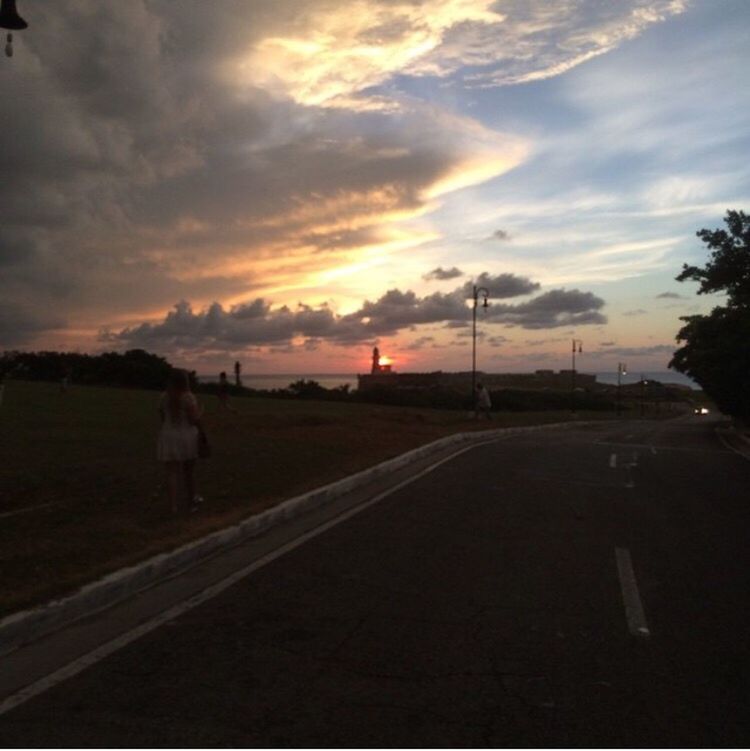 ROAD BY TREES AGAINST SKY DURING SUNSET