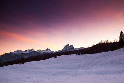 View of snow covered landscape during sunset