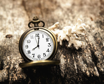 Close-up of antique pocket watch on wooden table