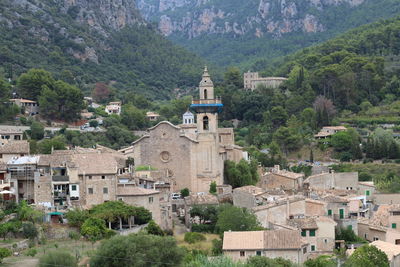 High angle view of trees and buildings against mountains