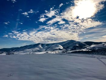 Scenic view of snowcapped mountains against sky during winter