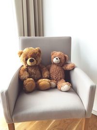 Teddy bears on armchairs at home
