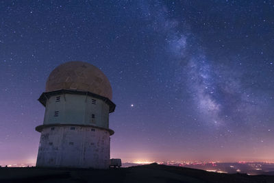 Low angle view of lighthouse against sky at night