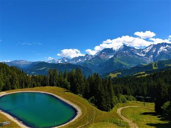 Scenic view of mountains against blue sky