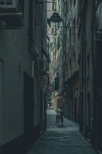 Narrow street amidst buildings in city