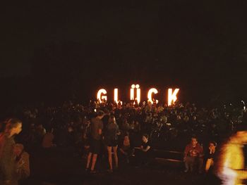 View of illuminated people at night