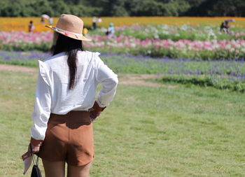 Rear view of woman standing in park