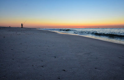 Scenic view of beach against sky during sunset