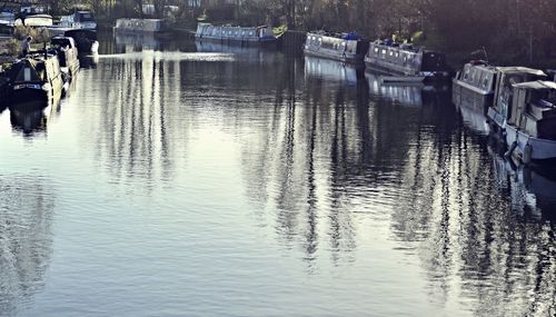 Boats moored in river in city