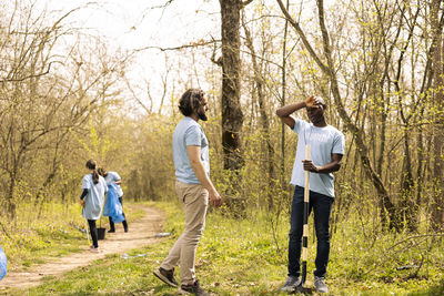 Rear view of couple walking in forest