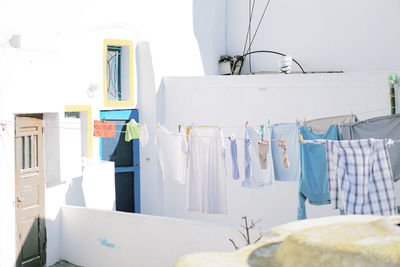 Clothes drying on clothesline against white wall