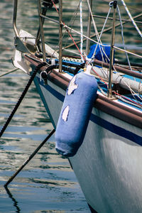 Close-up of sailboat moored in sea