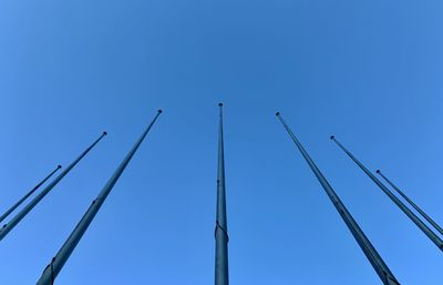 Low angle view of crane against clear blue sky