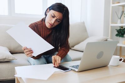 Businesswoman using laptop at table