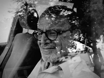 Close-up of man seen through car window 