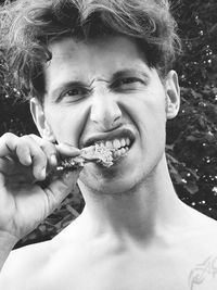 Portrait of young man eating outdoors