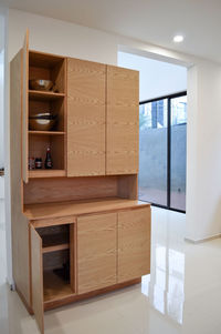 Modern wooden kitchen, with black or gray granite bar, with tile backsplash, light floor.