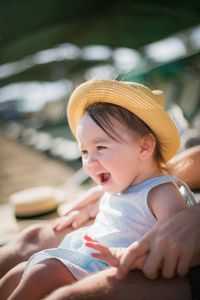 Cute baby girl sitting outdoors