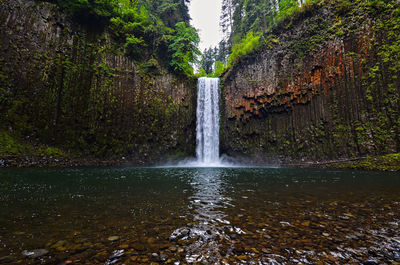 Low angle view of waterfall against sky