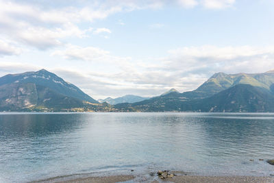 Scenic view of lake by mountains against sky