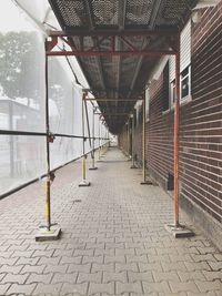 Empty footpath amidst buildings