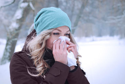 Woman blowing nose during winter