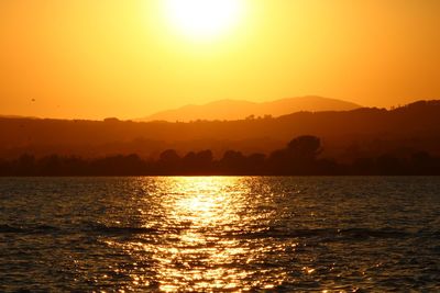 Scenic view of sea against orange sky