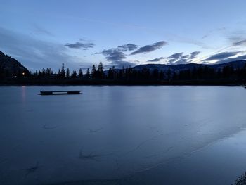 Scenic view of lake against sky during winter