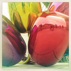 Close-up of multi colored glass on table
