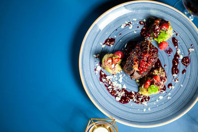 High angle view of food in bowl on blue background