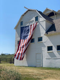 Low angle view of flags on field against sky