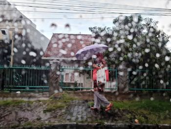 Full length of wet person walking in rain