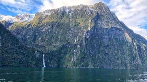 Scenic view of lake and mountains against sky