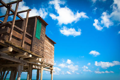 Low angle view of abandoned building against blue sky