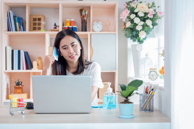 Young woman using smart phone at home