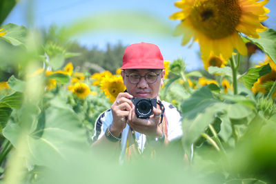 Young woman photographing through camera