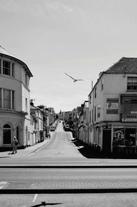 Street amidst buildings against sky in city