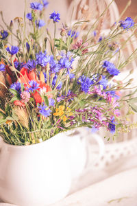 Close-up of purple flower pot on potted plant